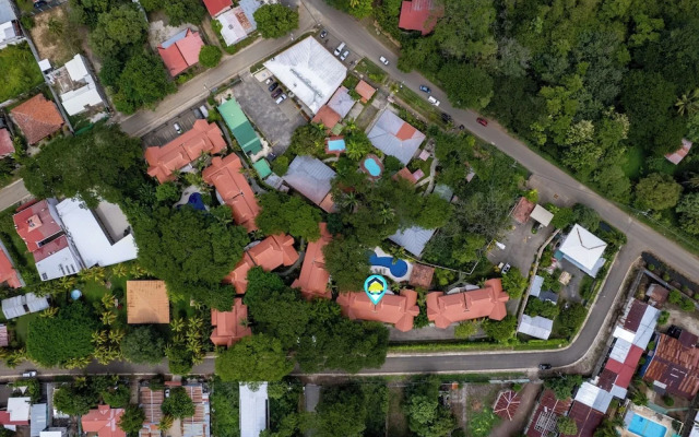 Modern Island-Themed Condo with Floor-to-Ceiling Windows & Garden and Pool Views Within Walking Distance of the Beach