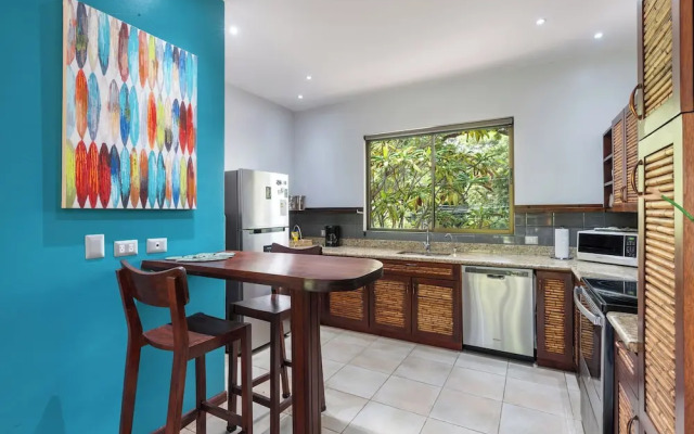 Modern Island-Themed Condo with Floor-to-Ceiling Windows & Garden and Pool Views Within Walking Distance of the Beach