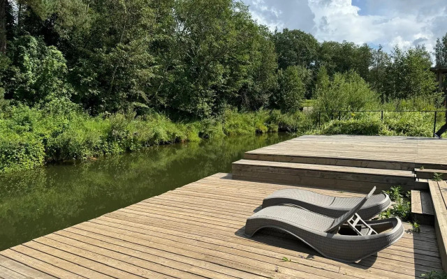 A-Frame house with a vat by the river