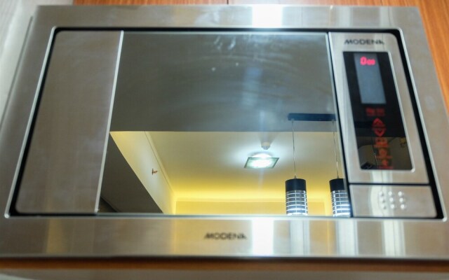 Comfortable 2BR @The Oasis Apartment By Travelio