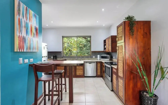 Modern Island-Themed Condo with Floor-to-Ceiling Windows & Garden and Pool Views Within Walking Distance of the Beach