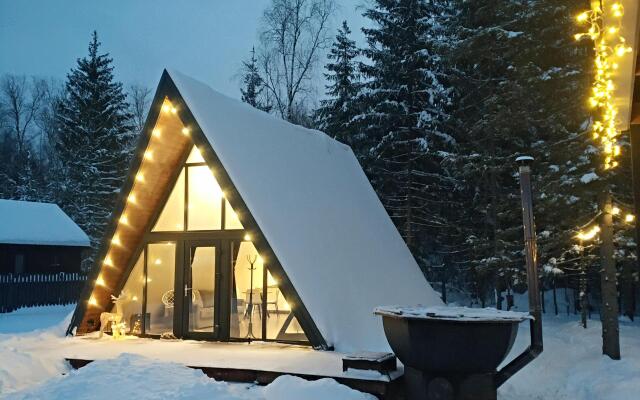 A-frame house with a bath tub near the forest