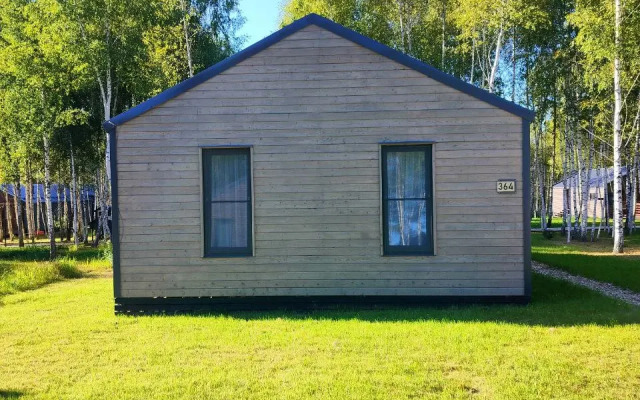 V Poselke U Vodokhranilischa Private house