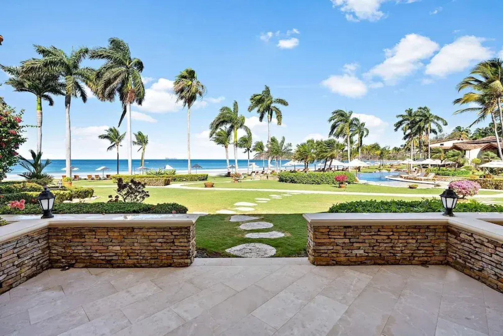 Luxury Beachfront Condo w/ High-End Wood Furnishings and Ocean Views in Exclusive Community