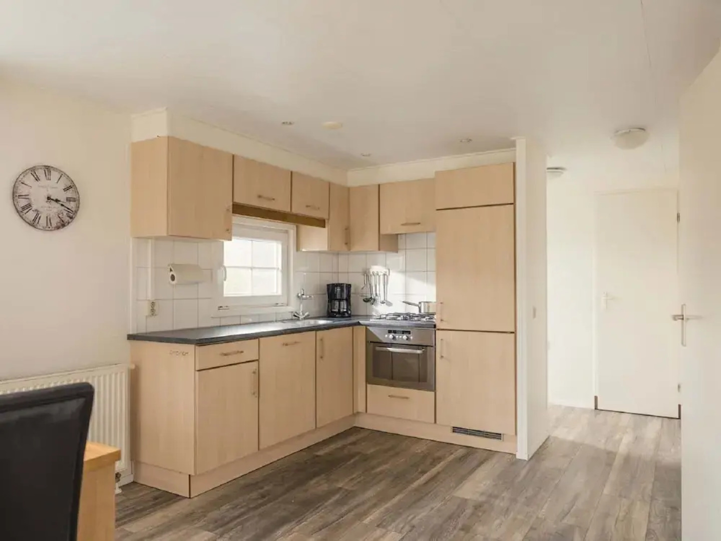 Comfy chalet with a dishwasher, directly on a pond