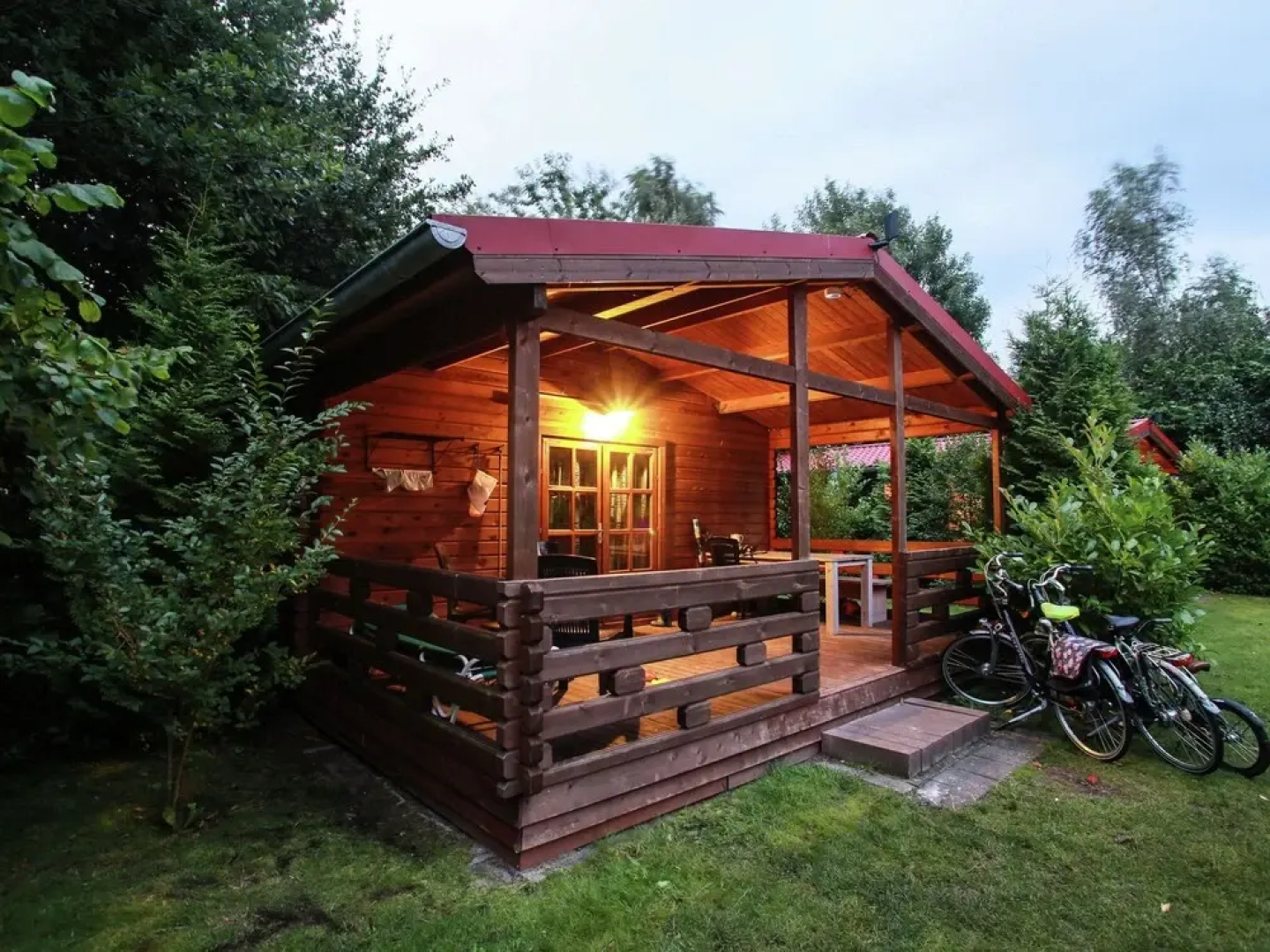 Wooden Cottage With a Veranda Located in a Natural Area