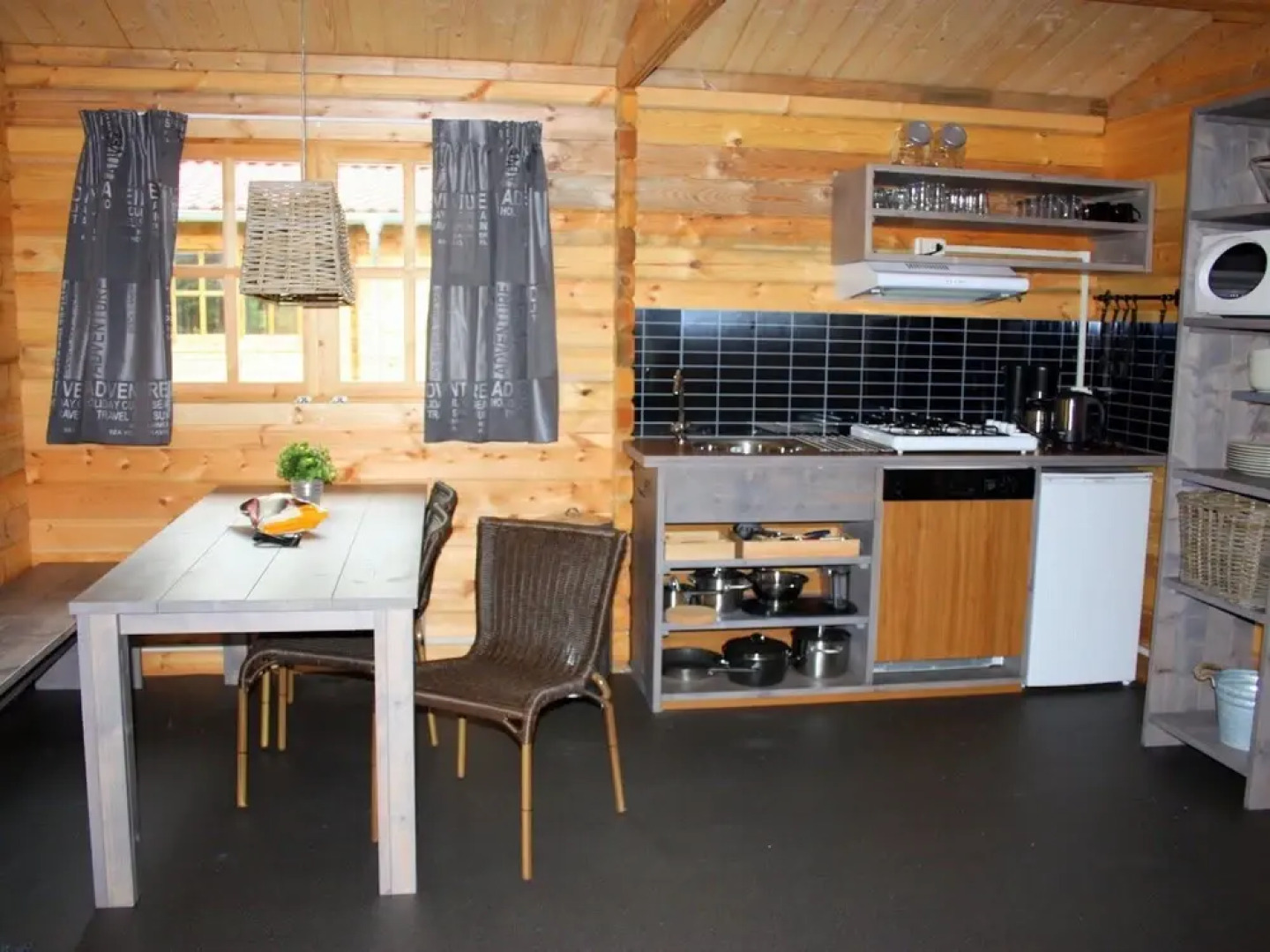 Wooden Cottage With a Veranda Located in a Natural Area