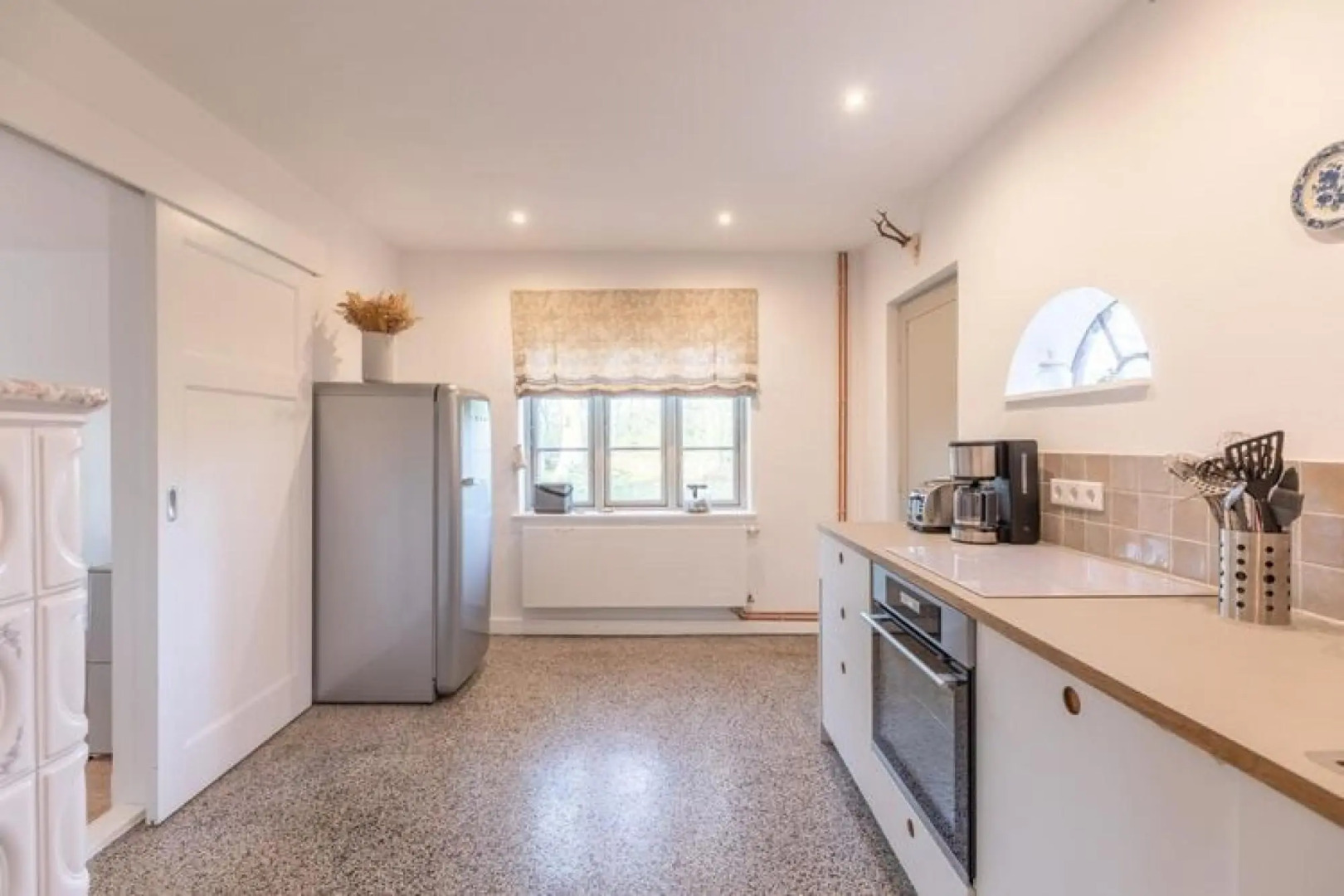 thatched cottage with tiled stove