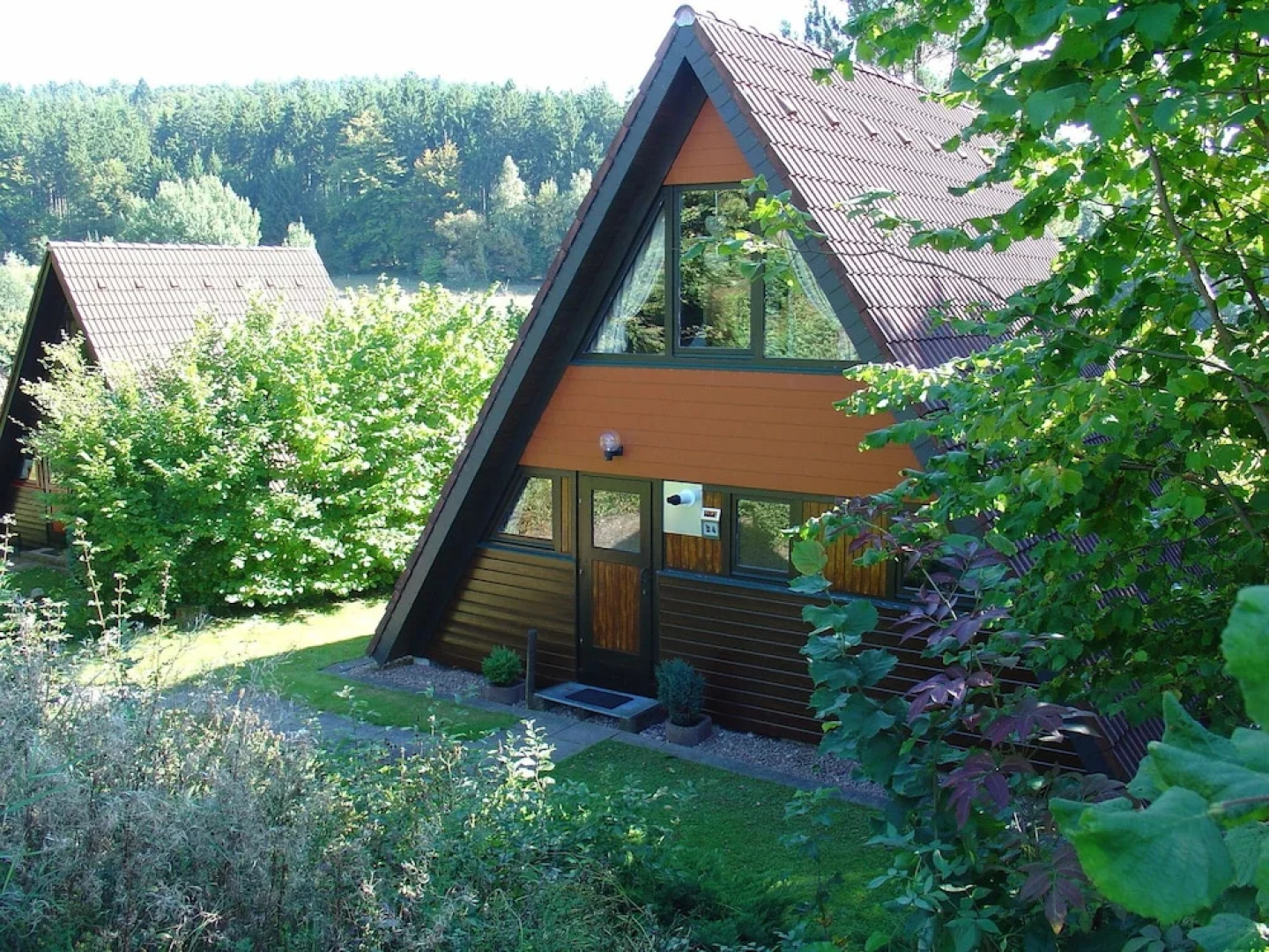 Detached, wooden bungalow with a terrace, in a wooded area