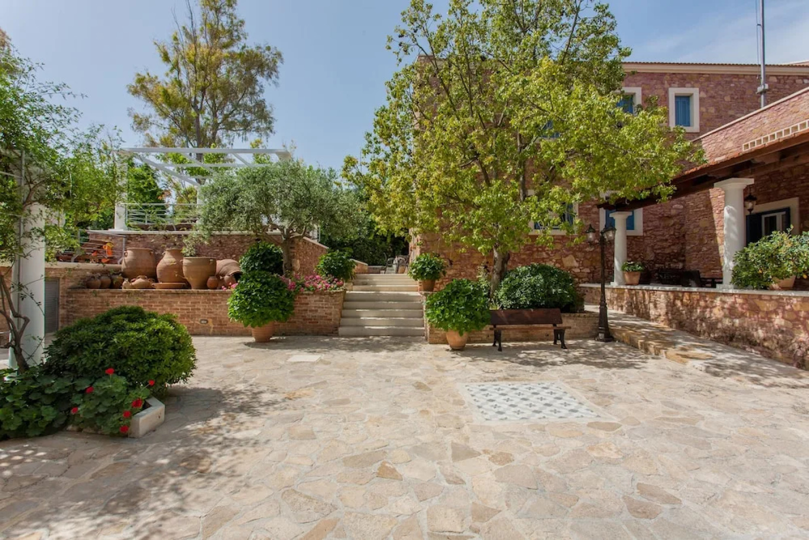 Dine on the Generous Veranda at a Rustic Stone Getaway