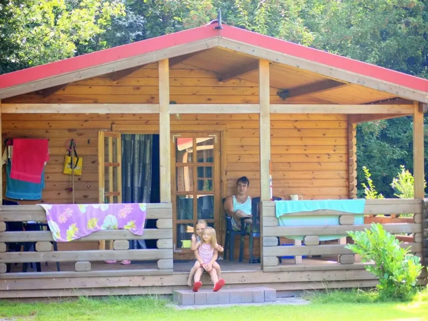 Wooden Cottage With a Veranda Located in a Natural Area