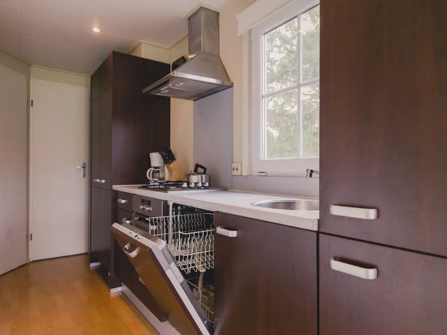 Comfy chalet with a dishwasher, directly on a pond