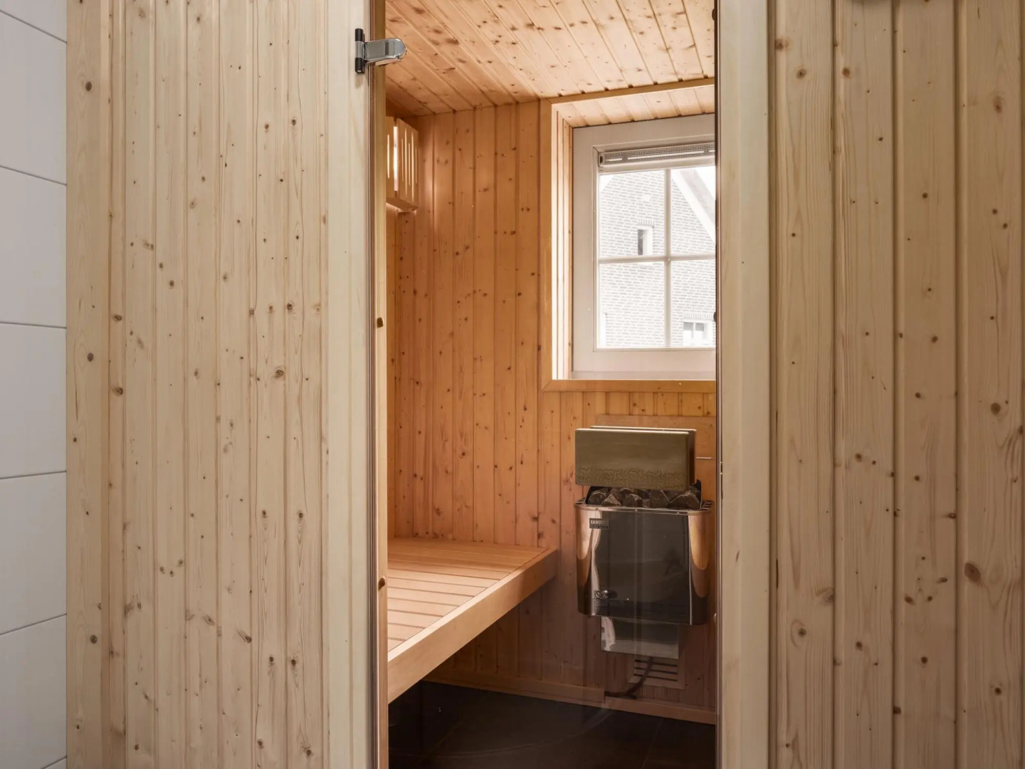 Thatched villa with sauna, in a holiday park surrounded by nature