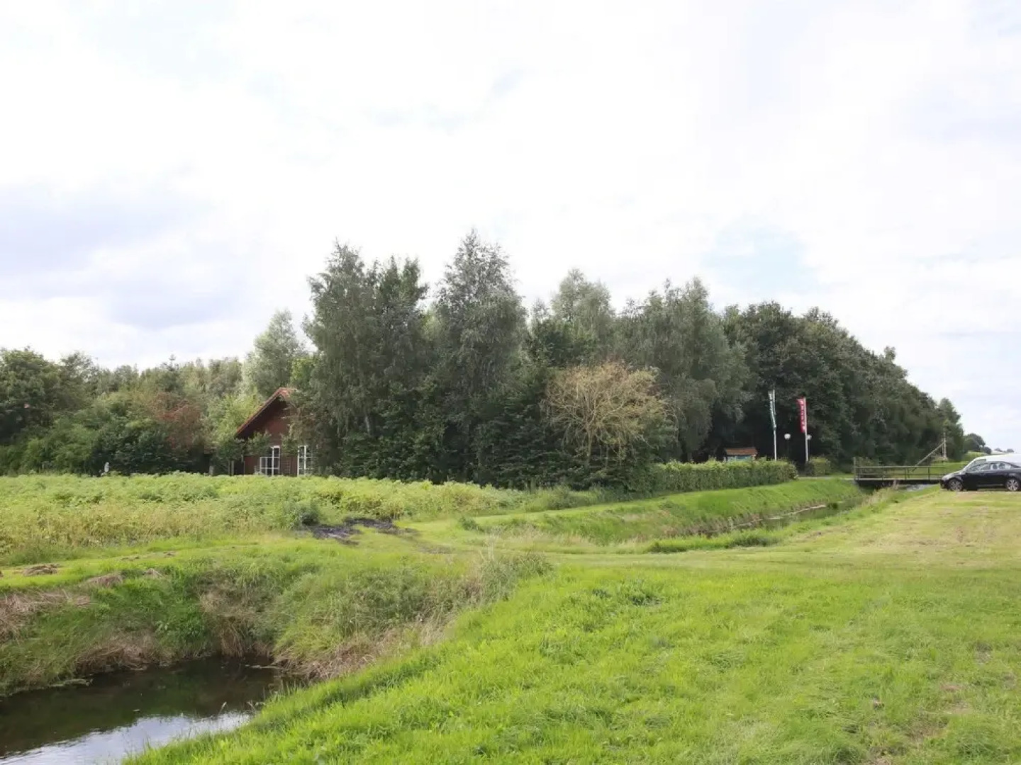 Wooden Cottage With a Veranda Located in a Natural Area