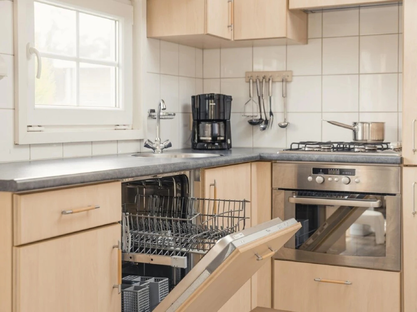 Comfy chalet with a dishwasher, directly on a pond