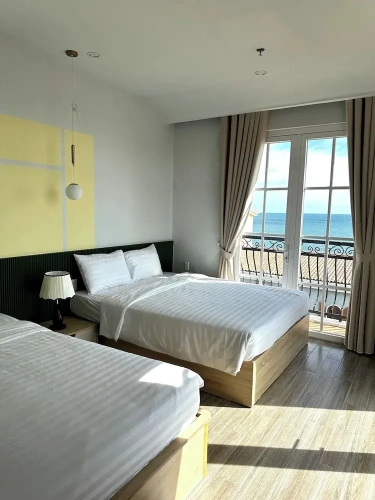 Deluxe Quadruple room with balcony and beachfront