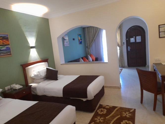 Standard Triple room with balcony and with garden view