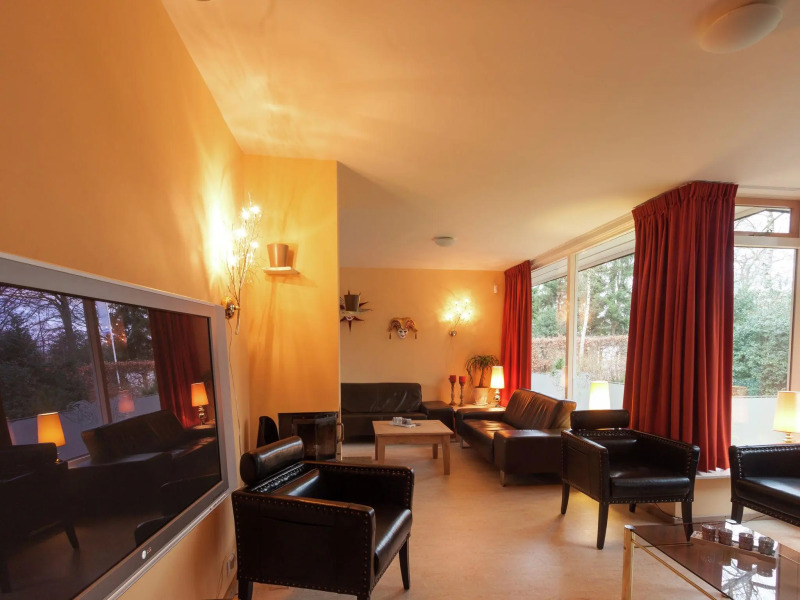 Cozy decorated house with fireplace, surrounded by forest