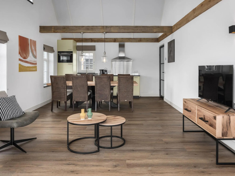 Thatched villa with sauna, in a holiday park surrounded by nature